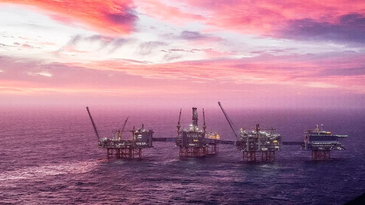 Equinor oil and gas platforms lit up at dusk in the North Sea
