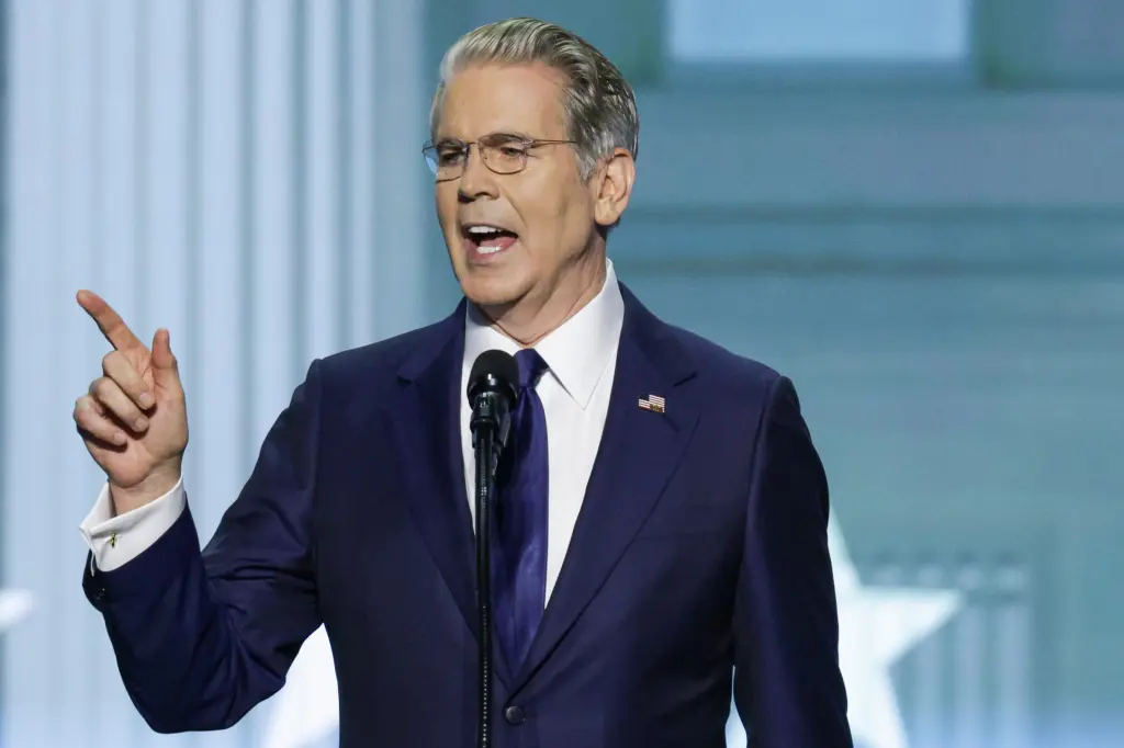 Treasury Secretary Scott Bessent gestures while speaking at a podium