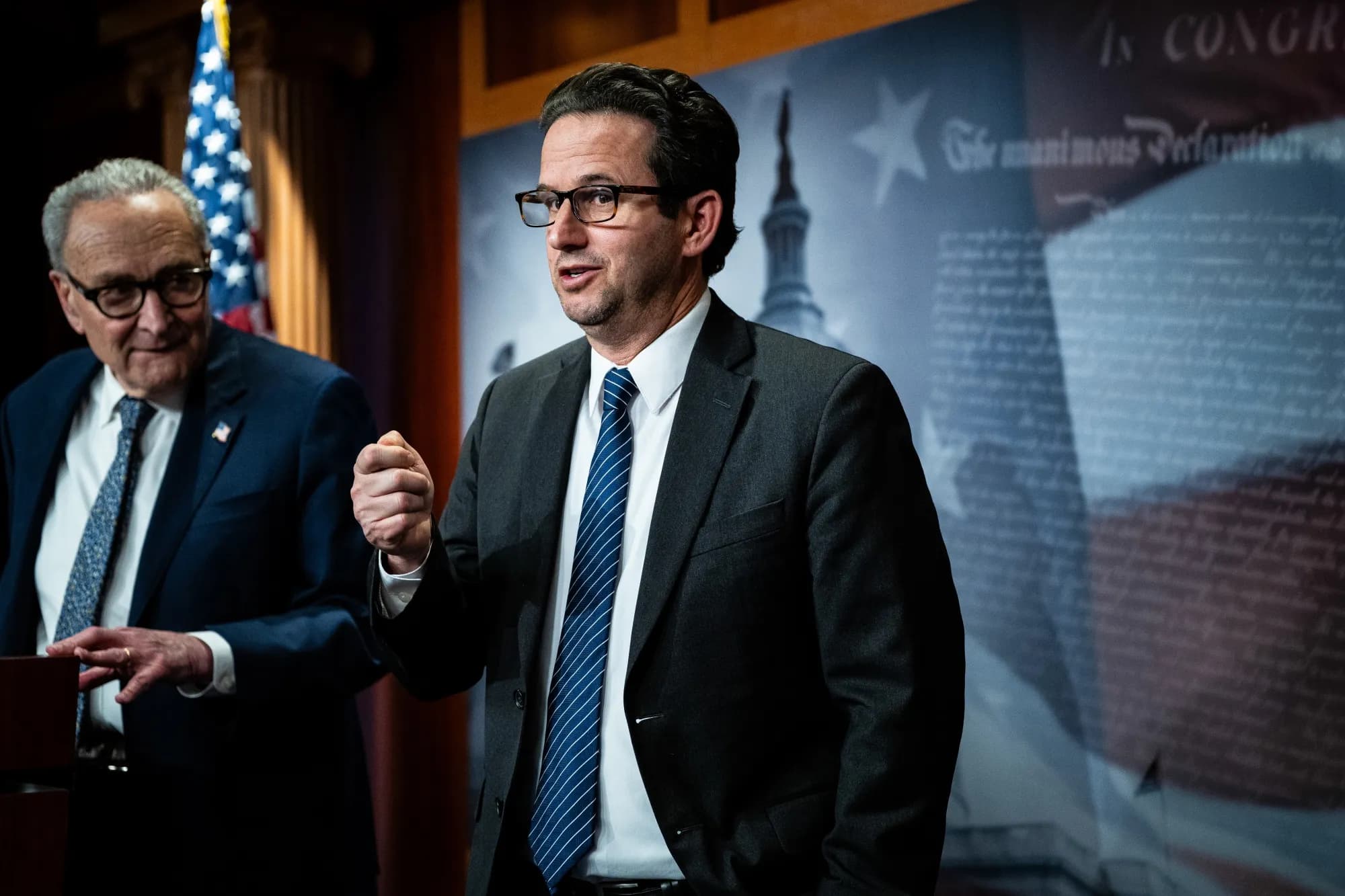 Senator Brian Schatz speaks at a press conference alongside Senator Chuck Schumer