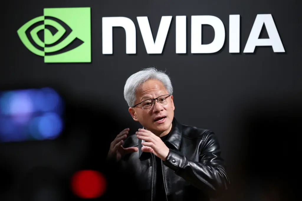 Nvidia CEO Jensen Huang speaks in front of the Nvidia logo