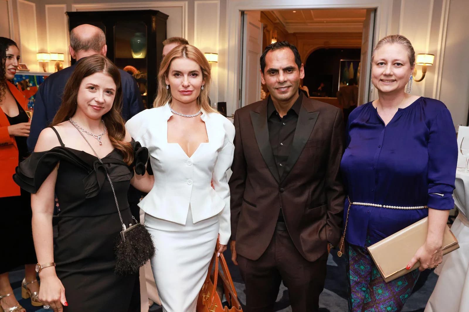 Four elegantly dressed guests posing together at THE Circle launch evening at the Baur au Lac in Zurich